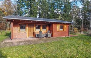 a log cabin with a patio in a yard at Awesome Home In Merzalben With Wi-Fi in Merzalben
