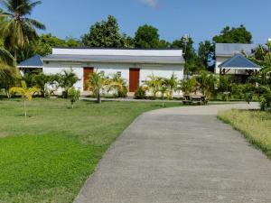 a white building with a pathway in front of it at Keshy island eden in Baillif
