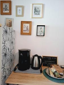 a coffee pot sitting on a table with a plate at Suite 4 pers dans village vacances in Sainte-Anne