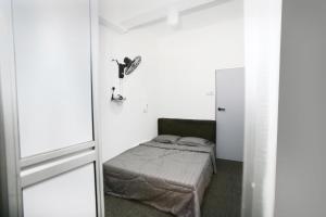 a small bedroom with a bed and a mirror at HangoutSpacez Queensbay at Bayan Lepas Penang in Bayan Lepas +32 photos