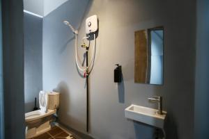 a bathroom with a toilet and a sink at HangoutSpacez Queensbay at Bayan Lepas Penang in Bayan Lepas