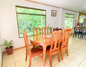 a dining room with a wooden table and chairs at Rayo de Luna in Monteverde Costa Rica +56 photos