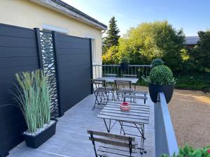 FondettesにあるLa campagne à 5 minutes de Tours.のパティオ(ベンチ、テーブル、フェンス付)