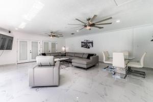 a large white living room with a couch and chairs at Poolside Opulence Tennis and HotTub in Corpus Christi