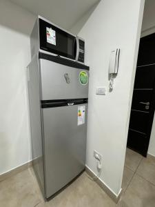 a refrigerator with a microwave on top of it at Rincón Montañas del Sur in Ushuaia