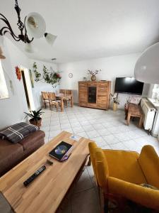 a living room with a couch and a table at Neue Ferienwohnung in Warnstedt mit Garten, Grill und Terrasse in Thale +9 photos