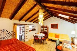 a bedroom with a bed and a table and chairs at Ferienhaus in El Risco mit Garten, Terrasse und Grill in Agaete