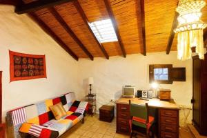 a living room with a couch and a desk at Ferienhaus in El Risco mit Garten, Terrasse und Grill in Agaete