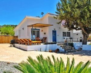 a house with a patio and a swimming pool at Alexandra's Sea Front Villa in Pefki