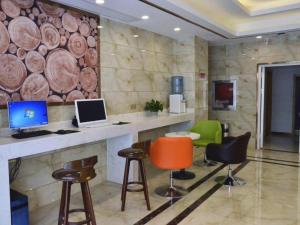 a room with a desk with two computers and chairs at GreenTree Inn Xuzhou Ruojia Express Hotel in Xuzhou