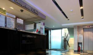 a lobby of a building with a line on the wall at Line Plus Hotel in Gimpo