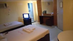 Postel nebo postele na pokoji v ubytování Bermuda Hotel