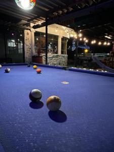 a pool table with balls on top of it at Vibes Aurik in Quito