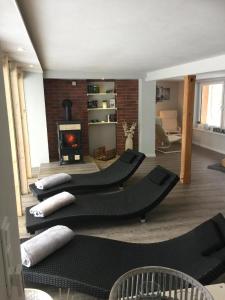 a living room with black furniture and a fireplace at Haus Waldesrauschen der Ferienanlage Rabenstein in Chemnitz