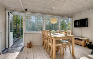 a dining room with a wooden table and chairs at Lovely Home In Hadsund With Kitchen in Hadsund