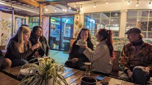 a group of people sitting around a table eating cake at Vibes Aurik in Quito