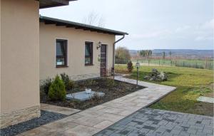a house with a yard next to a building at Awesome Apartment In Harzgerode in Harzgerode +12 photos
