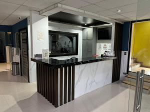 a lobby with a large counter in a building at Hotel Santa Cruz in Chihuahua