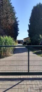a black fence in front of a driveway at Appartement in Buchenhain mit Großem Garten in Buchenhain