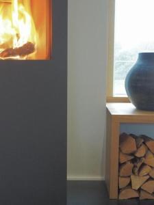 a vase sitting on a table next to a window at Exklusives Ferienhaus in Huppenbroich mit Terrasse, Grill und Garten in Simmerath