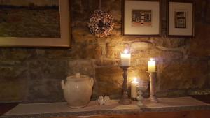 two candles sitting on a table with a stone wall at Ferienhaus für 4 Personen ca 100 qm in Nova Vas nad Dragonjo, Küstenland Slowenien in Nova Vas nad Dragonjo