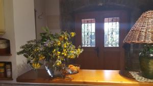 a table with a vase of flowers and a door at Ferienhaus für 4 Personen ca 100 qm in Nova Vas nad Dragonjo, Küstenland Slowenien in Nova Vas nad Dragonjo