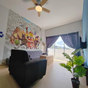 a living room with a couch and a ceiling fan at Muji Style brick themed Cameron Highland Homestay FREE Netflix in Tanah Rata