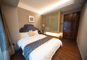 Krevet ili kreveti u jedinici u objektu Shenzhen Binhe Impression Hotel Apartments