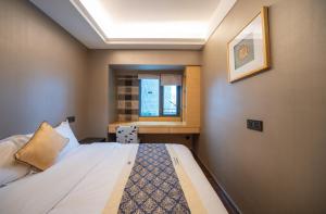 Krevet ili kreveti u jedinici u objektu Shenzhen Binhe Impression Hotel Apartments