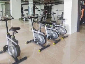 a row of exercise bikes in a gym at Luxurious Studio at Patraland Urbano Apartment By Travelio in Bekasi