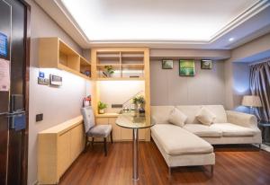 a living room with a couch and a table at Shenzhen Binhe Impression Hotel Apartments in Shenzhen