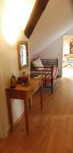 a room with a table and a bed with a mirror at Ferienwohnung mit herrlichem Moselblick in Piesport