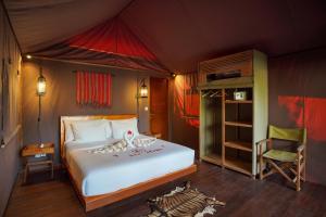 Un dormitorio con una cama en una tienda de campaña. en Gili Tenda, en Gili Trawangan