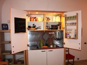 a small kitchen with white cabinets and a sink at Roman Forum Holiday Fori in Rome