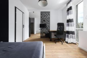 a bedroom with a desk and a chair at Będzińska Oaza Komfortu in Będzin
