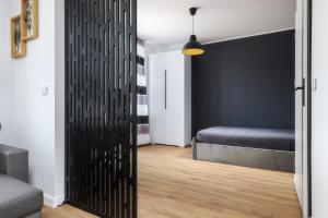 a bedroom with a sliding door with a bed at Będzińska Oaza Komfortu in Będzin +3 photos