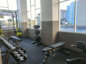 a gym with rows of chairs and machines at Best Deal and Restful Studio Apartment Suncity Residence By Travelio in Sidoarjo