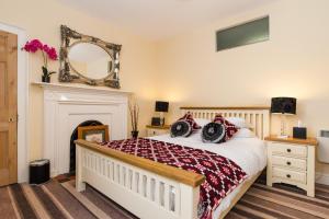 a bedroom with a bed with a fireplace and a mirror at CWTCH APARTMENT by the sea in Aberystwyth