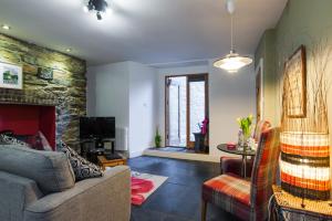 a living room with a couch and a fireplace at CWTCH APARTMENT by the sea in Aberystwyth