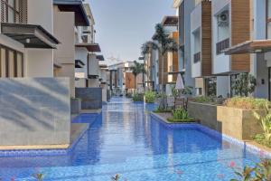 an image of a swimming pool in the middle of a building at Comfy and Modern Look 2BR Asatti Apartment By Travelio in Tangerang
