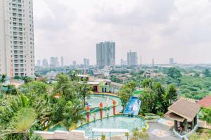a view of a swimming pool at a resort at Simply and Cozy Pool View 2BR at Great Western Apartment By Travelio in Pumpangsineng