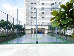a tennis court in front of a building at Best Deal and Restful 1BR Vasanta Innopark Apartment By Travelio in Cikarang