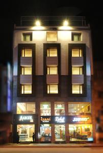 a tall building with lights in front of a store at Hotel Abode in Amritsar