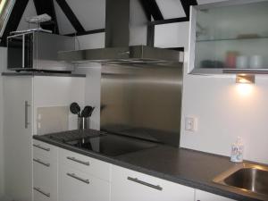 a kitchen with a stainless steel stove and a sink at Am Sternberg 36 in Frankenau