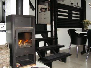 a fireplace in a living room with a table and chairs at Am Sternberg 36 in Frankenau