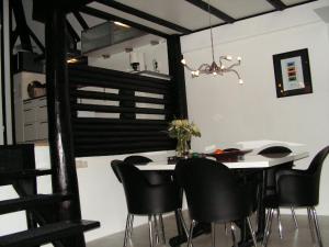 a dining room with a table and black chairs at Am Sternberg 36 in Frankenau