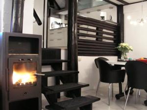 a fireplace in a living room with a stove at Am Sternberg 36 in Frankenau +8 photos