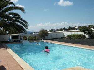 a person swimming in a swimming pool at Villa mit Pool und herrlichem Meerblick in Playa Blanca