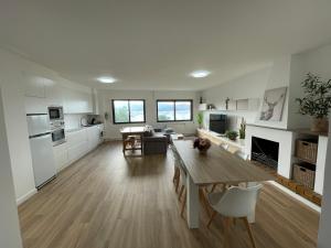 a kitchen and living room with a table and chairs at Mirador Puerto Náutico, con parking gratis, in Moaña +60 photos