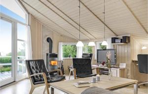 a living room with black chairs and a table at Three-Bedroom Holiday Home In Allinge in Allinge